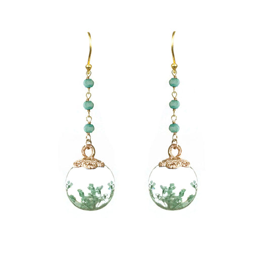 Gena Myints Petrified Flower Keepsake Amazonite Earrings feature dangling earrings with green beads and round spheres showcasing small plant-like designs.