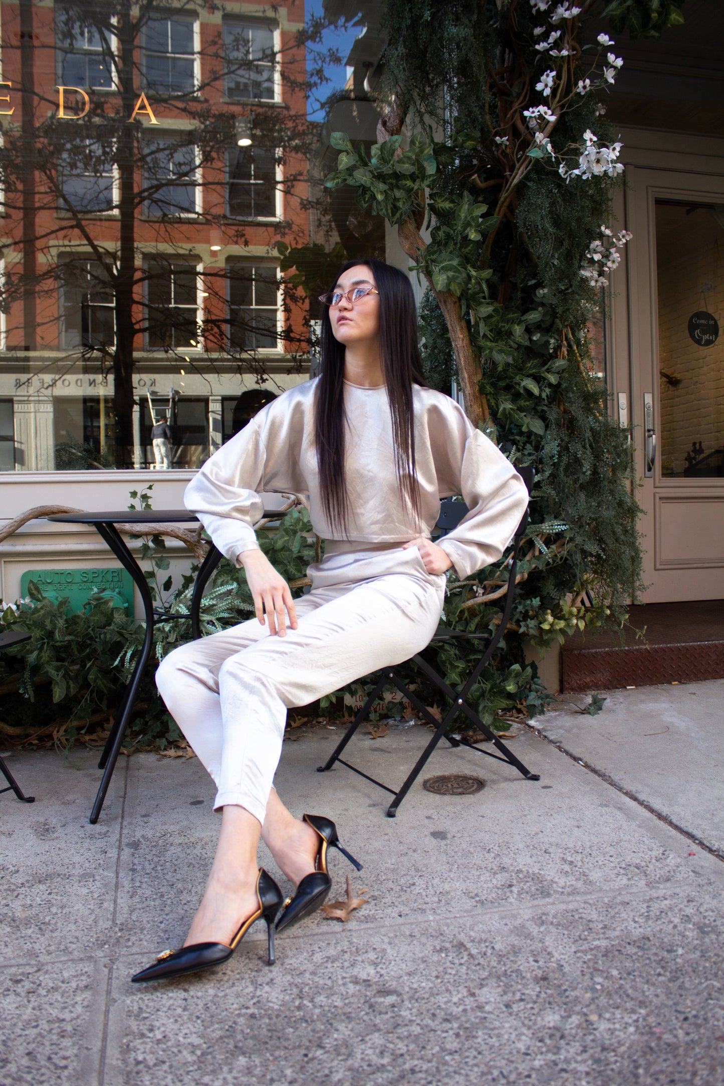 Sophie Beige Pants by Le Réussi®: Silk satin high-waisted trousers in light cream, shown from the back.