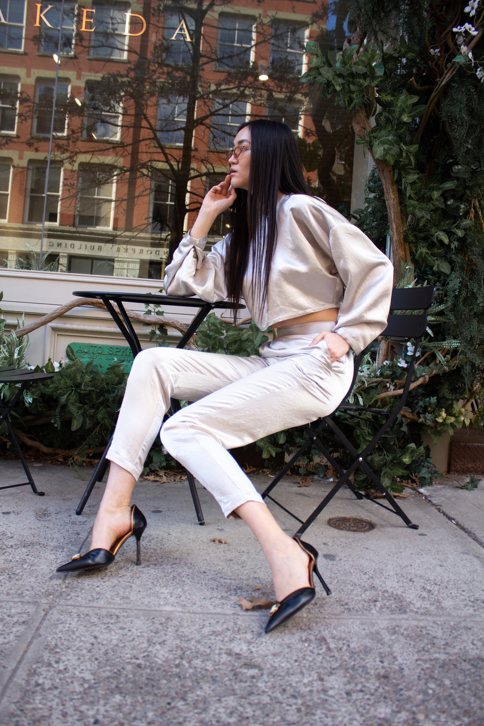 Sophie Beige Pants by Le Réussi®: Silk satin high-waisted trousers in light cream, shown from the back.