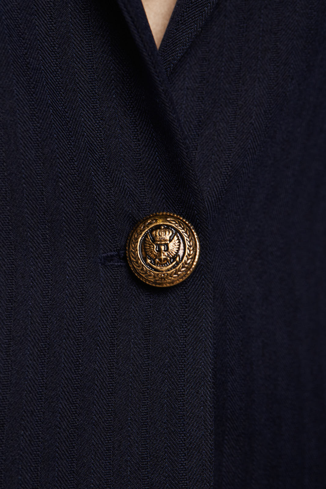 A blonde person stands against a white background wearing a Le Réussi® Navy Peak-Lapels Single-Breasted Blazer and matching pants.