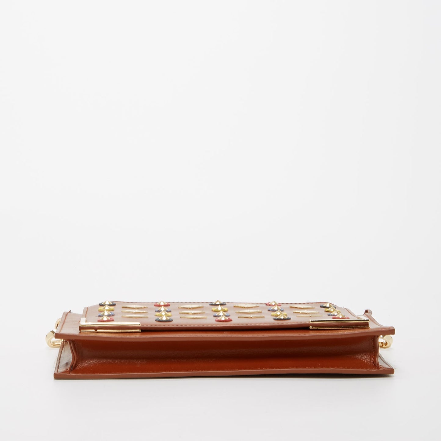 Brown Studded Crossbody Clutch by SUSU features colorful circular and diamond-shaped studs, a gold chain strap, and a zip closure.