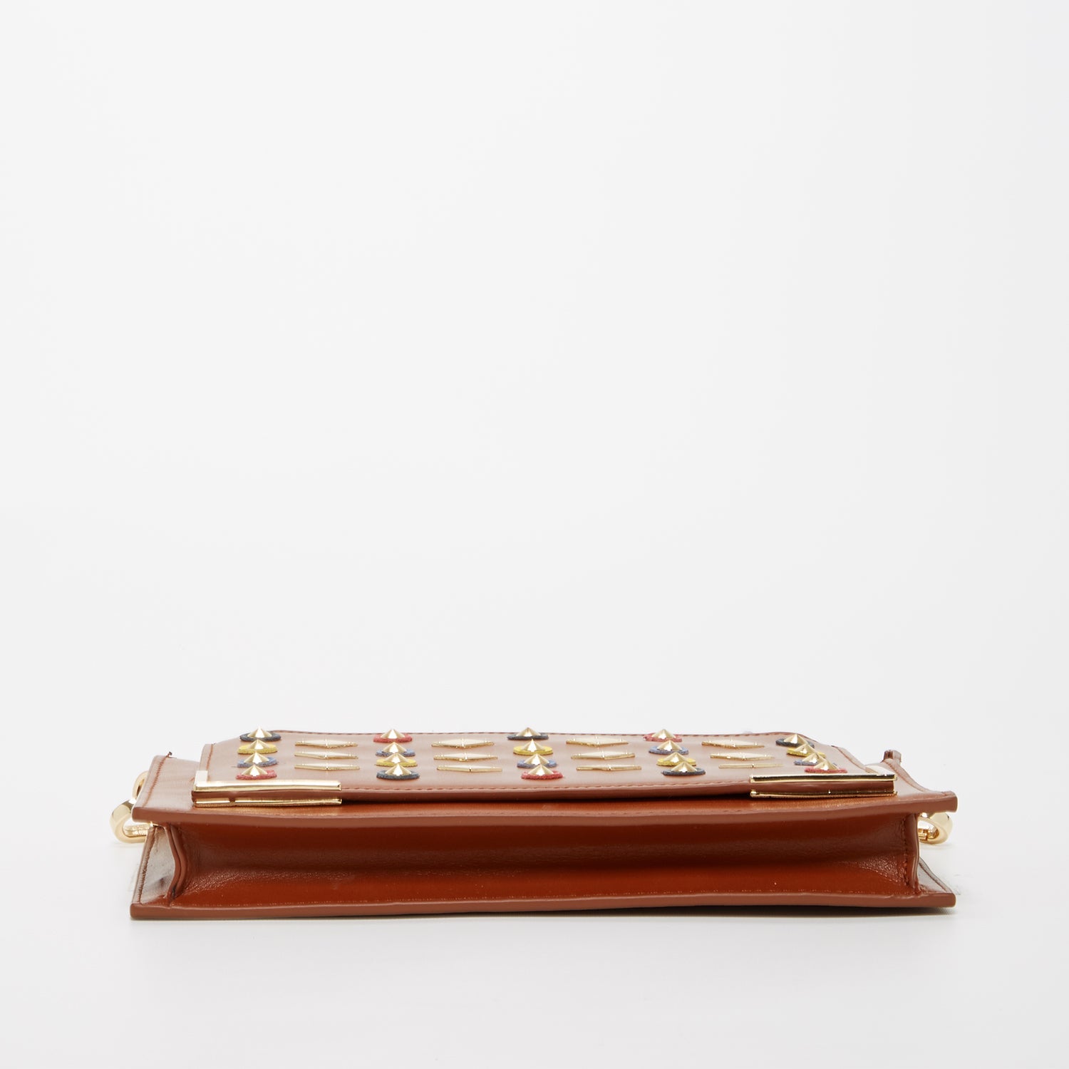 Brown Studded Crossbody Clutch by SUSU features colorful circular and diamond-shaped studs, a gold chain strap, and a zip closure.